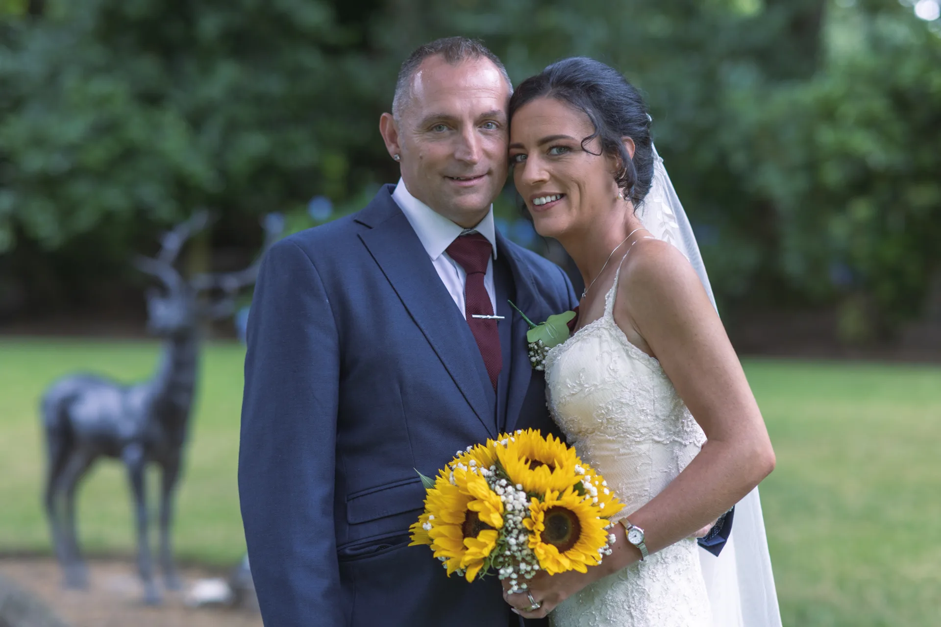 Newlywed couple with a sunflower bouquet